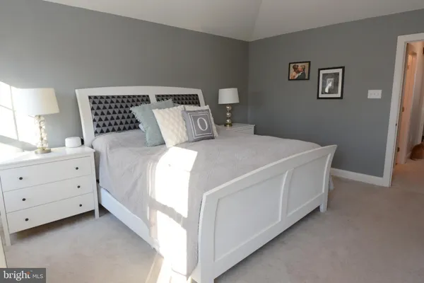 a bedroom with a bed and a television