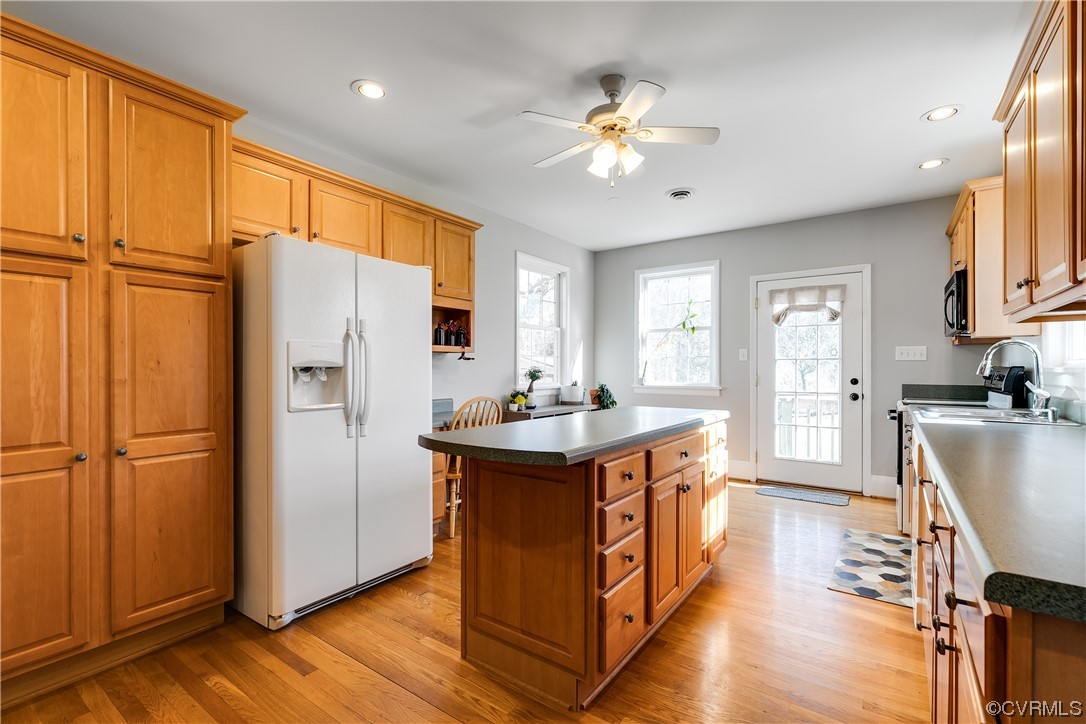 13409 Oak Lane Midlothian, VA 23113 - Photo 6 of 19 a kitchen with stainless steel appliances granite countertop a refrigerator a sink dishwasher a stove and white countertops with wooden floor
