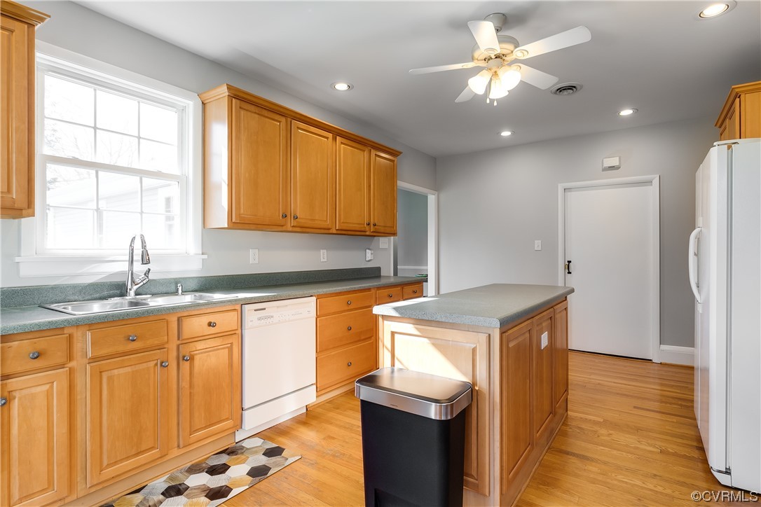 13409 Oak Lane Midlothian, VA 23113 - Photo 8 of 19 a kitchen with granite countertop a sink a stove cabinets and wooden floor