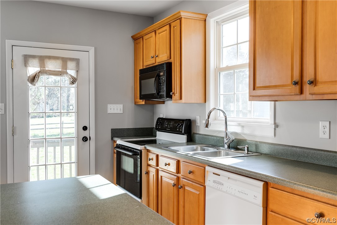 13409 Oak Lane Midlothian, VA 23113 - Photo 9 of 19 a kitchen with stainless steel appliances granite countertop a sink a stove and a microwave