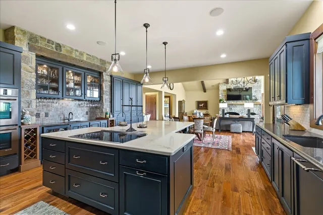 a living room with furniture ceiling fan and a large window