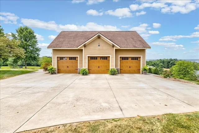 a bedroom with a bed a flat screen tv and a large window