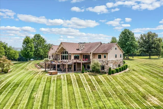 a view of a big house with pool and a big yard