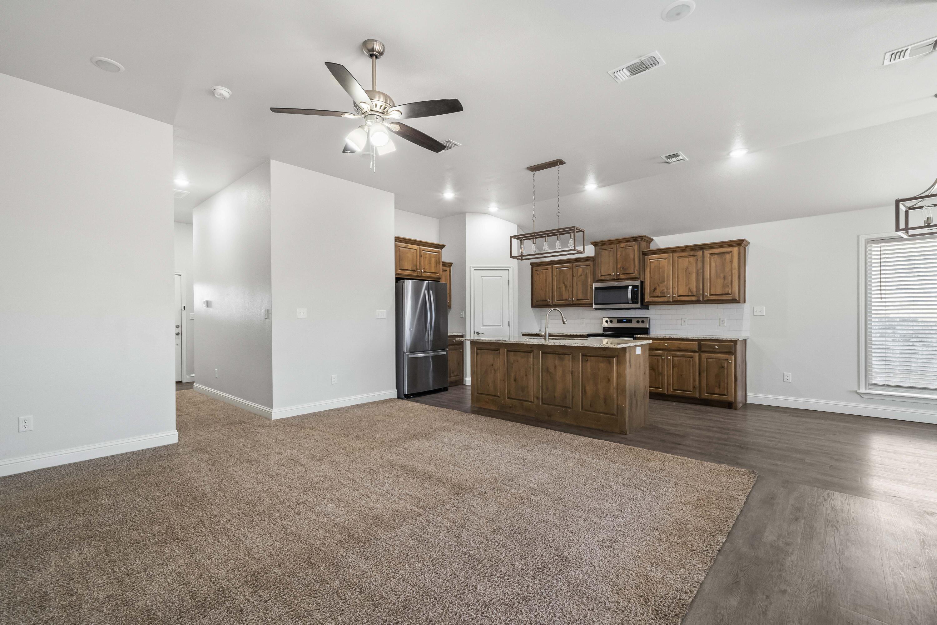 7523 87th Street Lubbock, TX 79424 - Photo 3 of 23 a view of kitchen with sink refrigerator and window