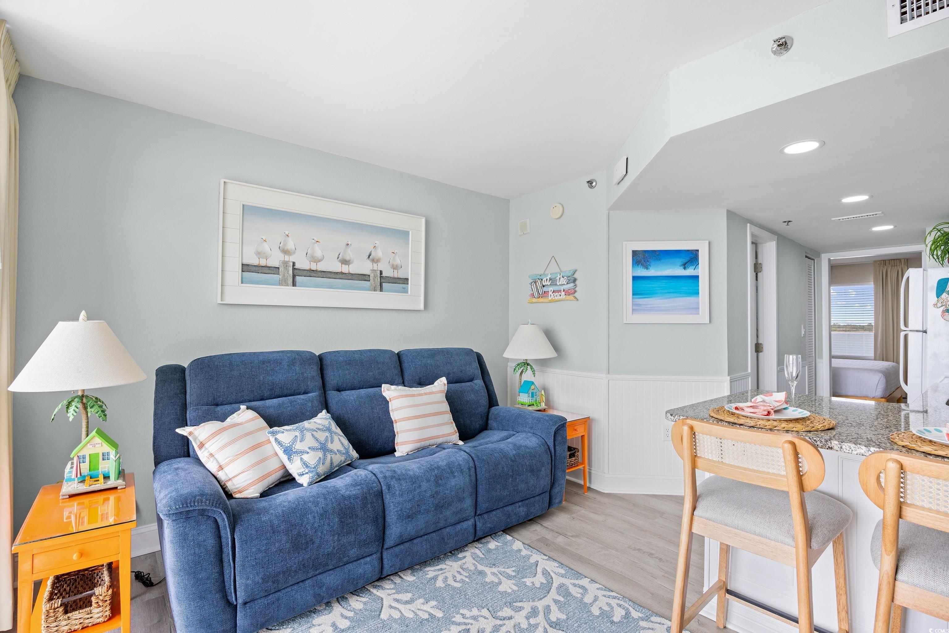 161 Seawatch Drive, Unit 1012 Myrtle Beach, SC 29572 - Photo 15 of 34 Living room with light wood finished floors, recessed lighting, and wainscoting
