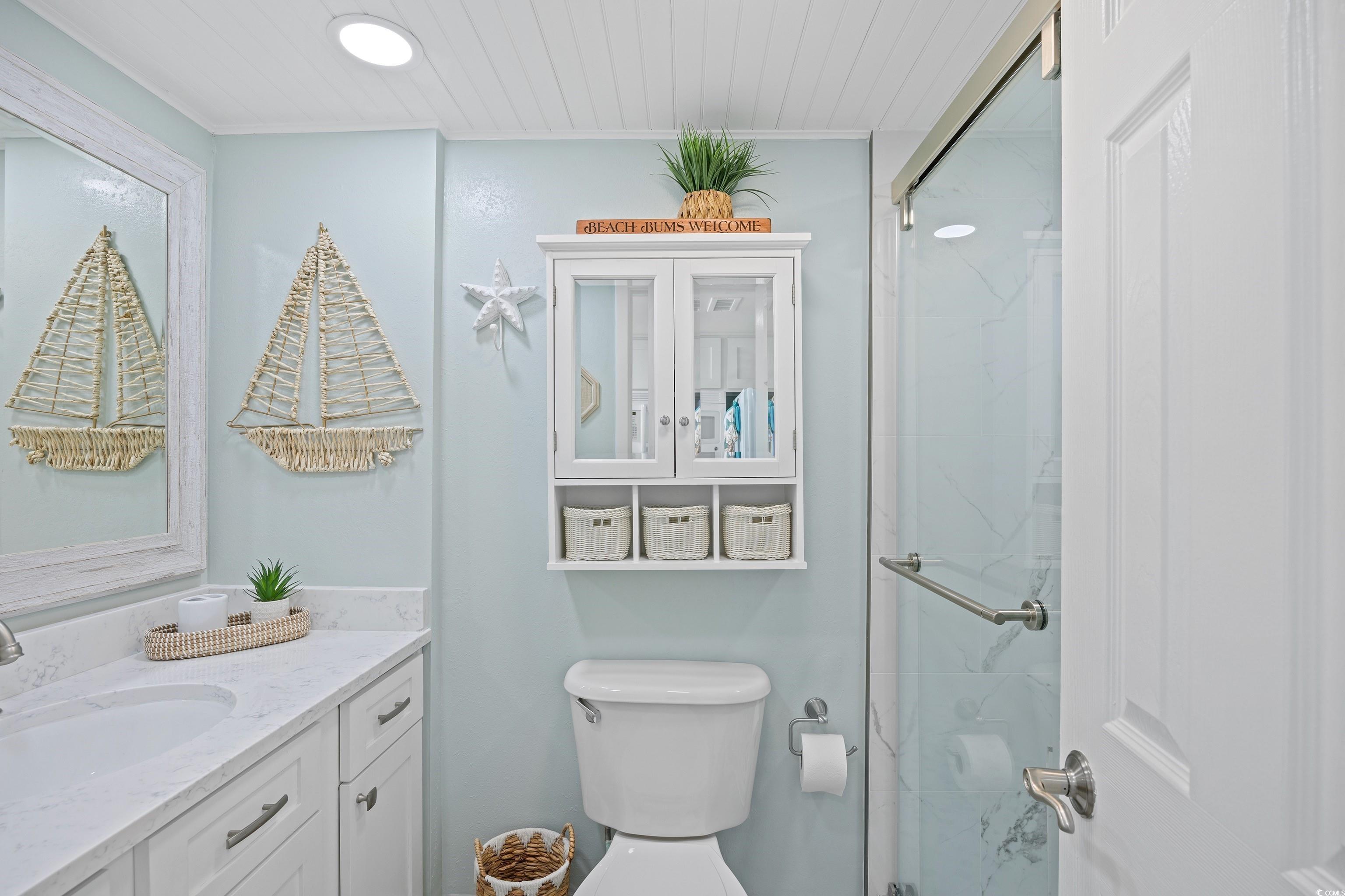 161 Seawatch Drive, Unit 1012 Myrtle Beach, SC 29572 - Photo 24 of 34 Full bathroom with vanity and a marble finish shower
