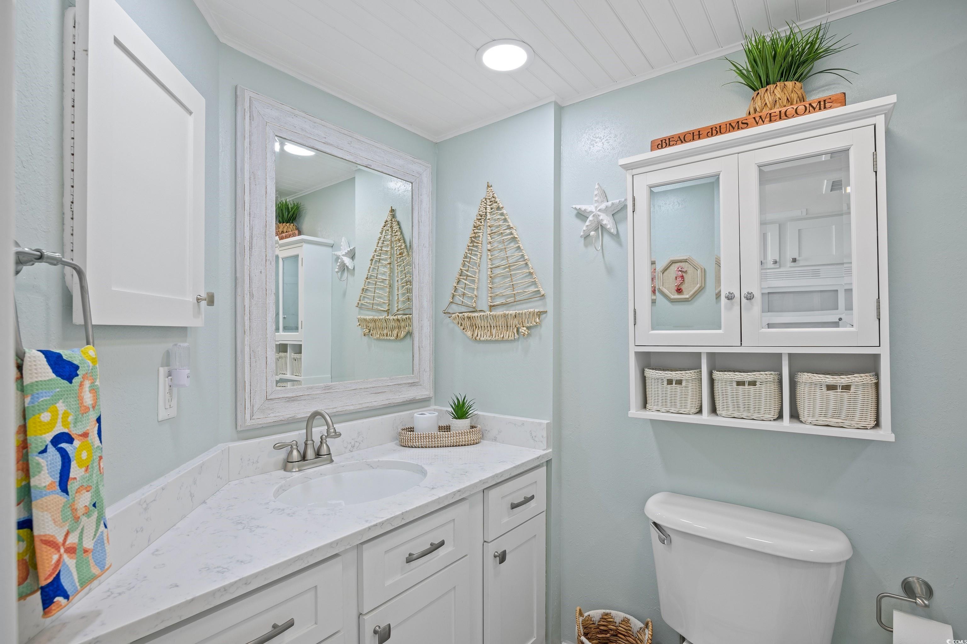 161 Seawatch Drive, Unit 1012 Myrtle Beach, SC 29572 - Photo 25 of 34 Half bath with vanity and crown molding