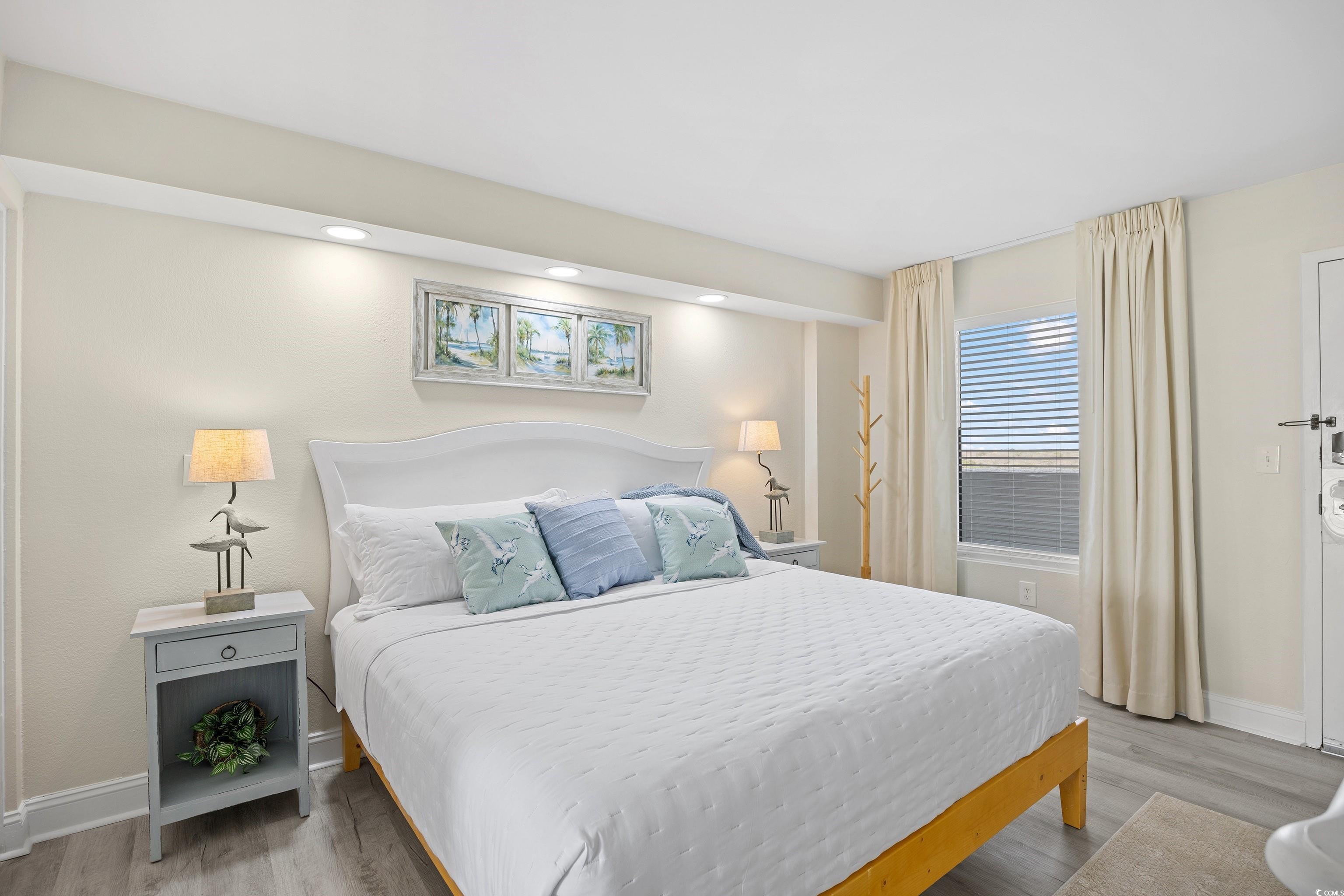 161 Seawatch Drive, Unit 1012 Myrtle Beach, SC 29572 - Photo 30 of 34 Bedroom with multiple windows, light wood finished floors, and recessed lighting