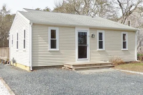 a view of a house with a small backyard