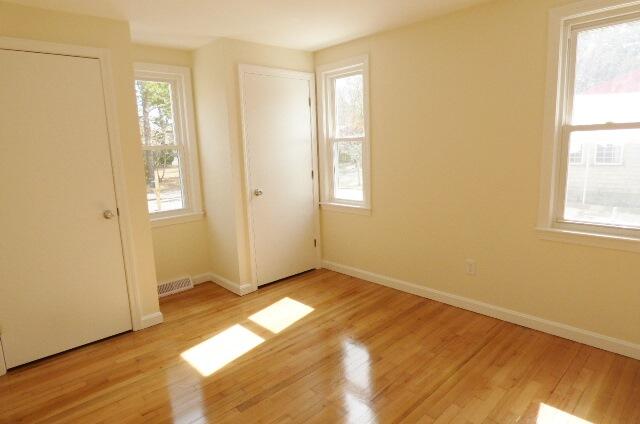 3 Circuit Road North West Yarmouth, MA 02673 - Photo 15 of 28 a view of an empty room with wooden floor and a window