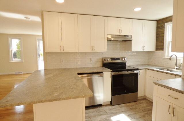 3 Circuit Road North West Yarmouth, MA 02673 - Photo 6 of 28 a kitchen with stainless steel appliances granite countertop a sink stove and cabinets