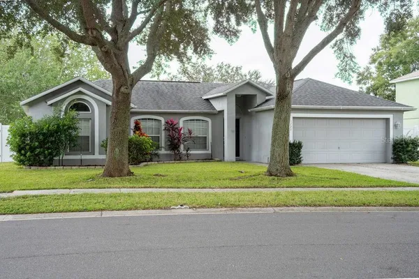 a front view of a house with a yard and a garage