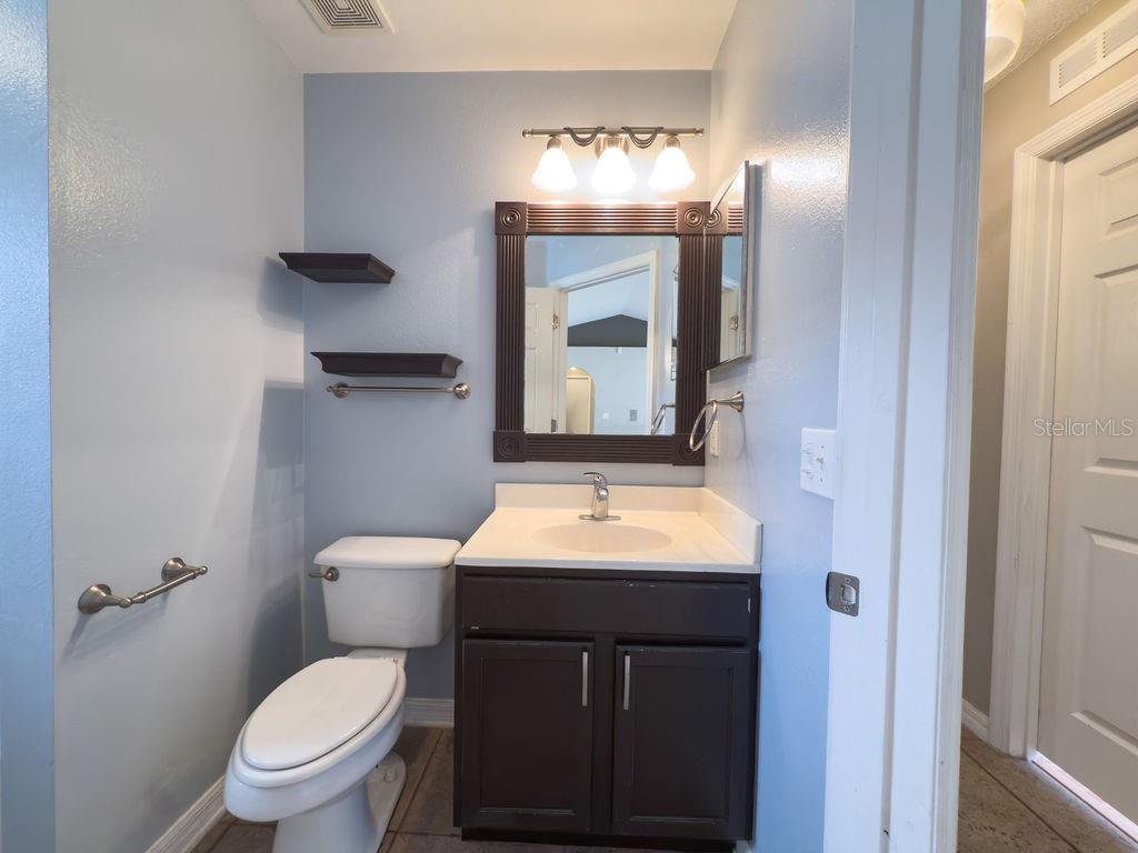 1723 Lochshyre Loop Ocoee, FL 34761 - Photo 16 of 23 a bathroom with a toilet sink and mirror