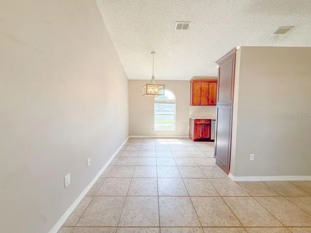 a view of a kitchen with a sink and a cabinet