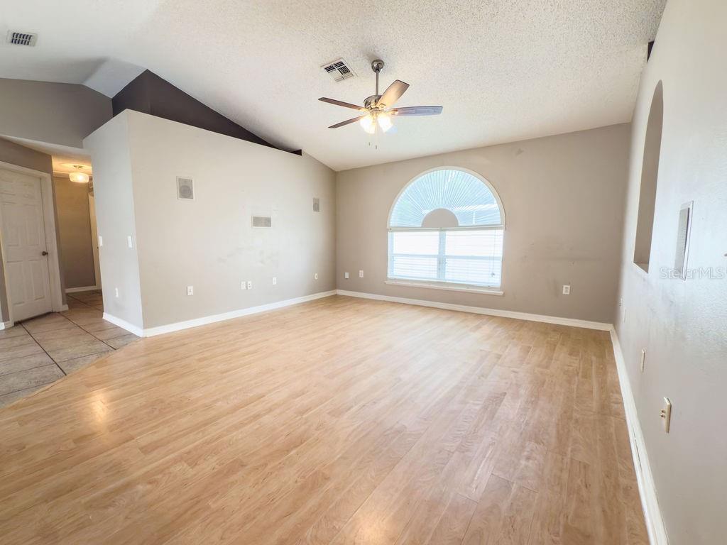 1723 Lochshyre Loop Ocoee, FL 34761 - Photo 8 of 23 a view of an empty room with a window and wooden floor