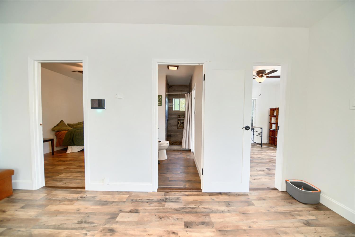 131 5th Street Gustine, CA 95322 - Photo 33 of 92 a view of a hallway with wooden floor and dining room