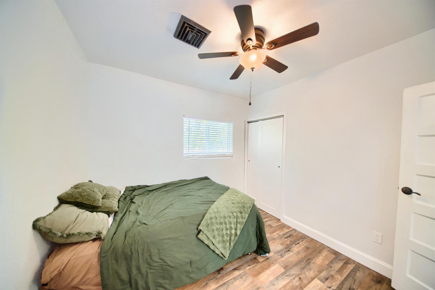 131 5th Street Gustine, CA 95322 - Photo 39 of 92 a view of a bedroom with a bed and a ceiling fan