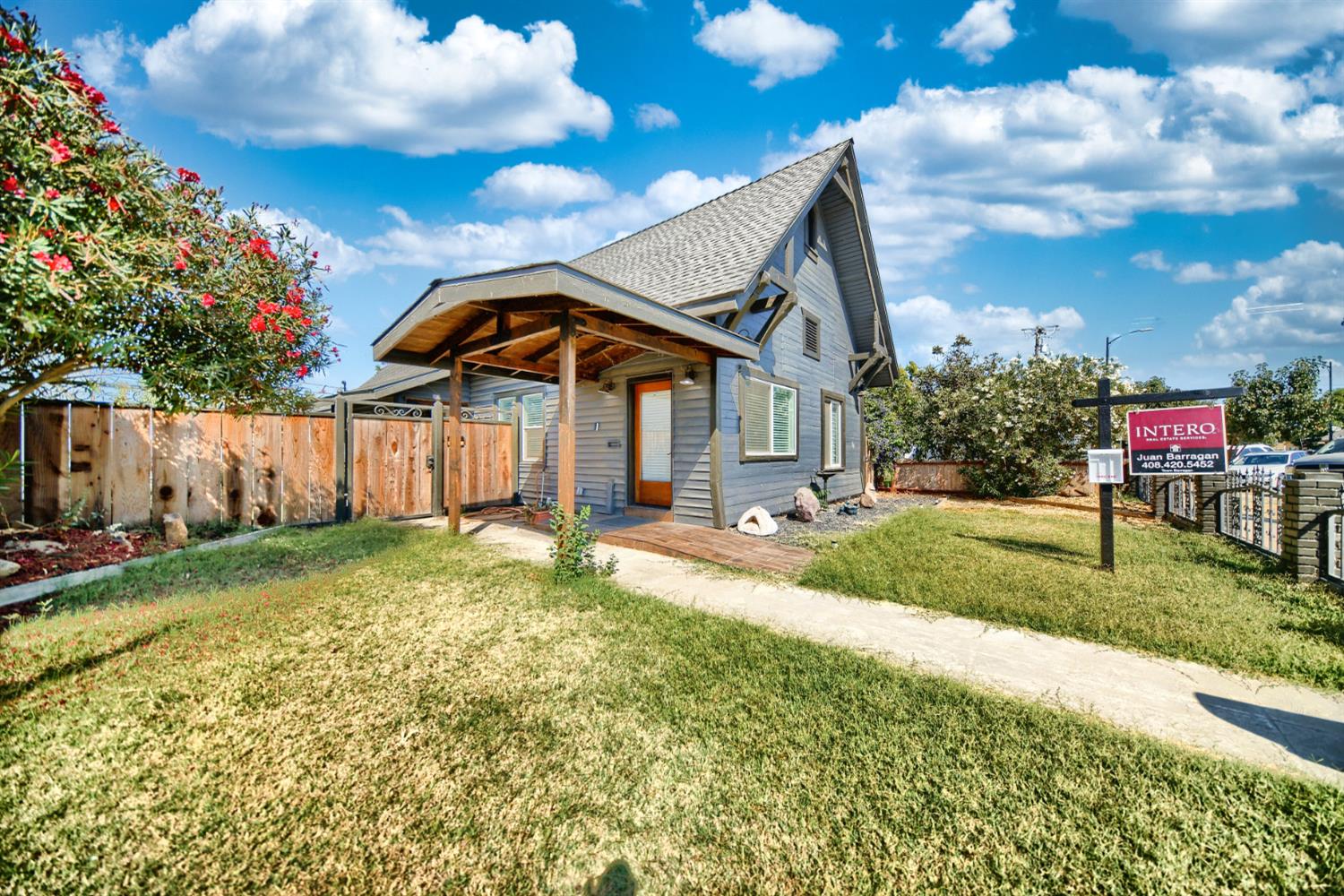 131 5th Street Gustine, CA 95322 - Photo 4 of 92 a view of a house with a yard potted plants and a large tree