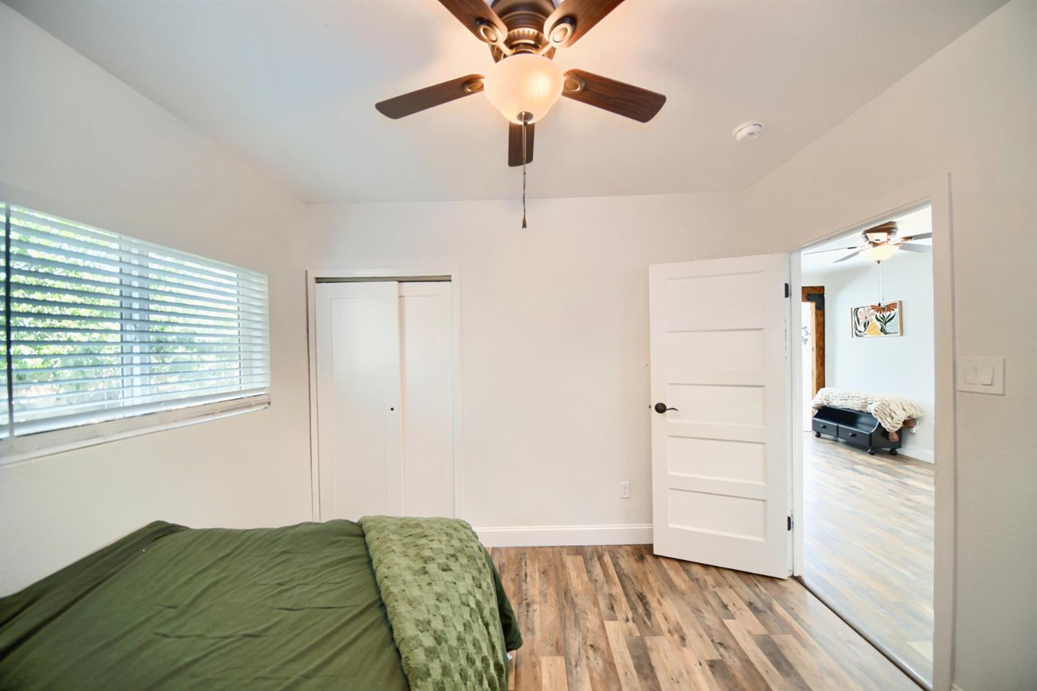 131 5th Street Gustine, CA 95322 - Photo 41 of 92 a view of a bedroom with wooden floor and a ceiling fan