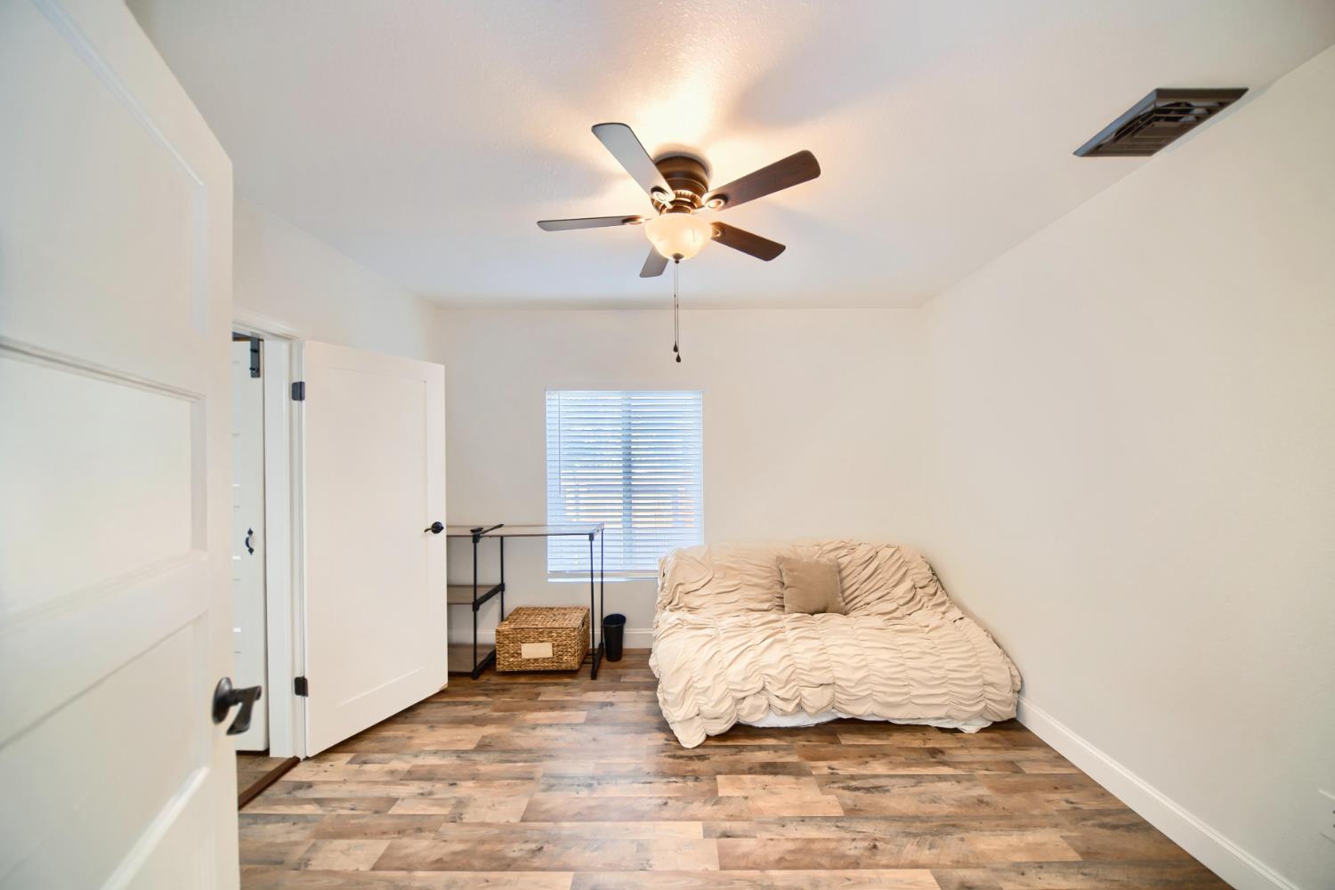 131 5th Street Gustine, CA 95322 - Photo 49 of 92 a bedroom with a bed and a ceiling fan