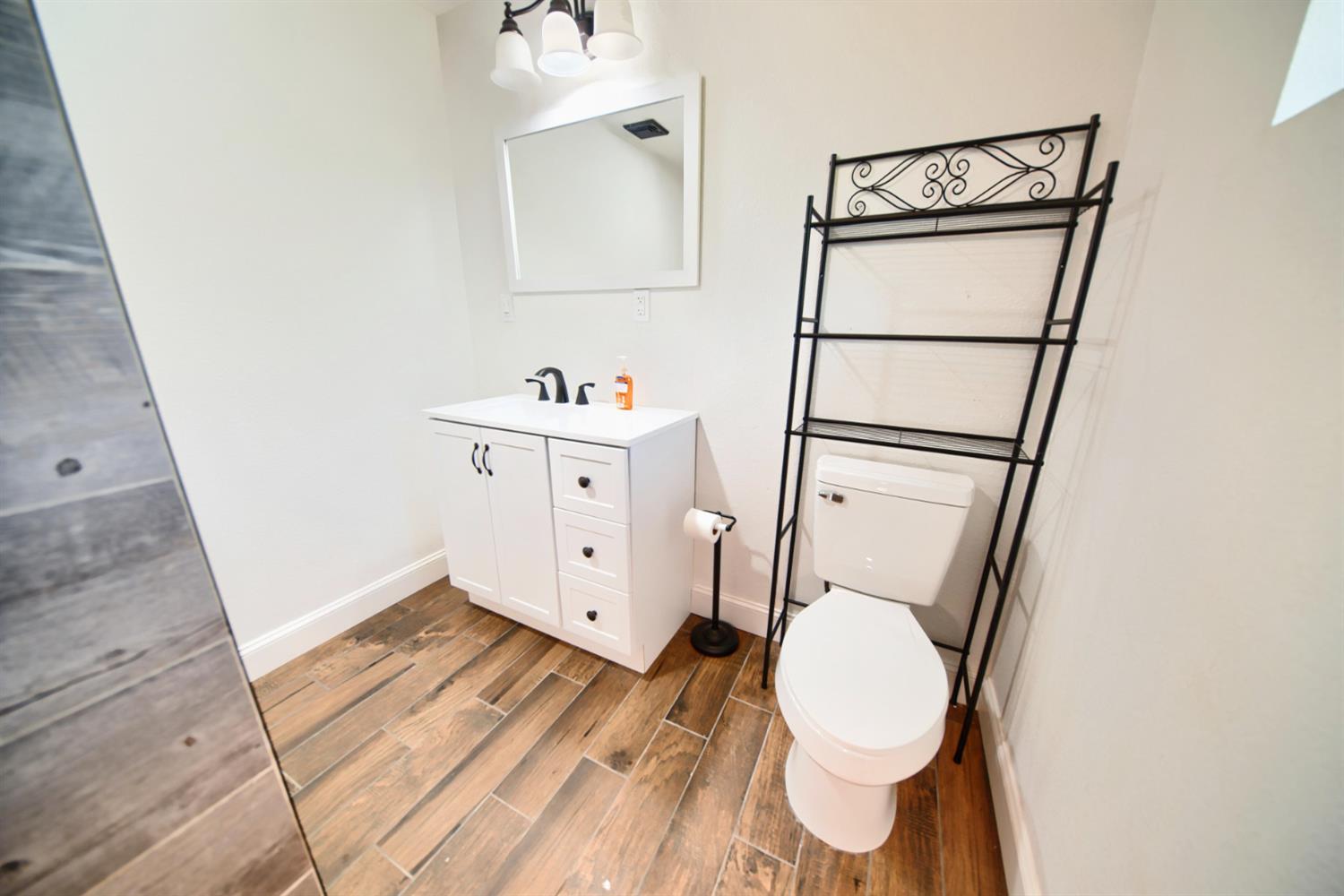131 5th Street Gustine, CA 95322 - Photo 56 of 92 a bathroom with a sink and a mirror