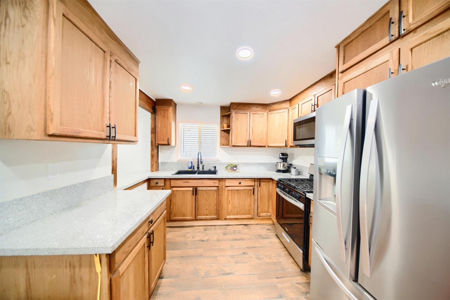 131 5th Street Gustine, CA 95322 - Photo 59 of 92 a kitchen with stainless steel appliances granite countertop a refrigerator a stove top oven a sink and dishwasher