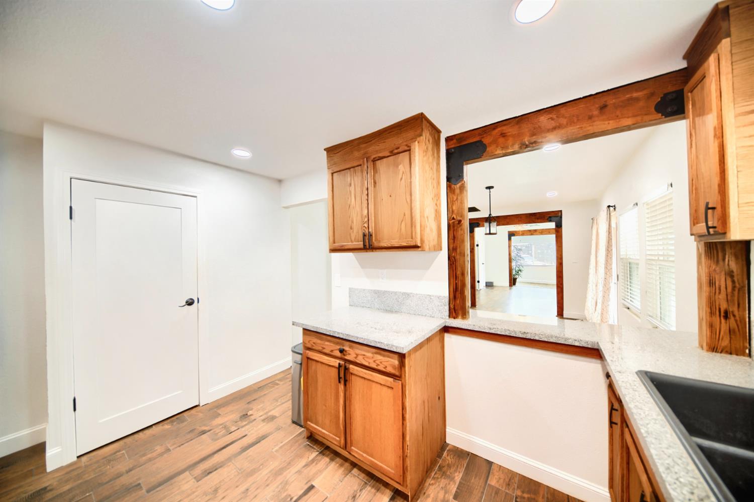 131 5th Street Gustine, CA 95322 - Photo 64 of 92 a kitchen with stainless steel appliances granite countertop a refrigerator a stove and a sink with wooden floor