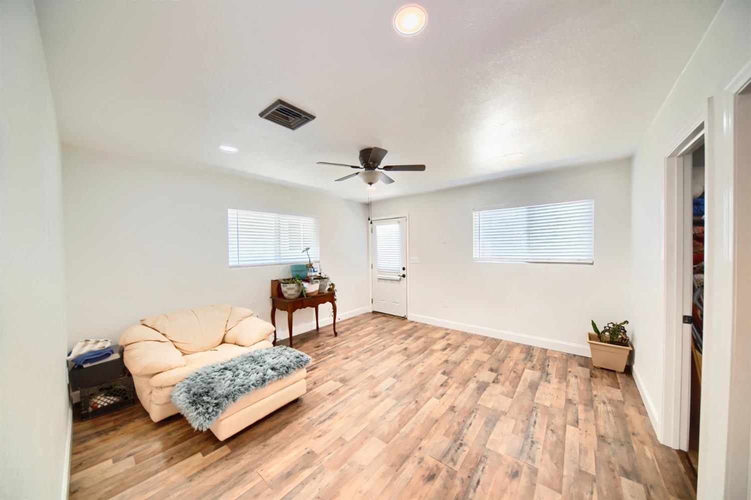 131 5th Street Gustine, CA 95322 - Photo 65 of 92 a bedroom with furniture and a wooden floor