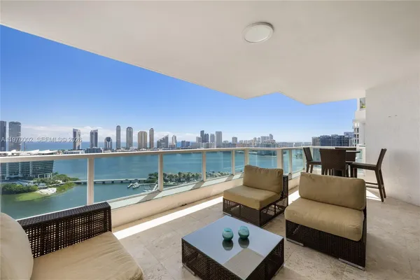 a view of a terrace with couches and city view