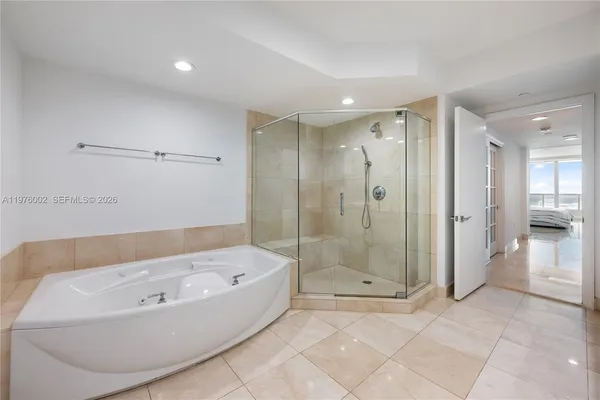 a bathroom with a bathtub and a shower