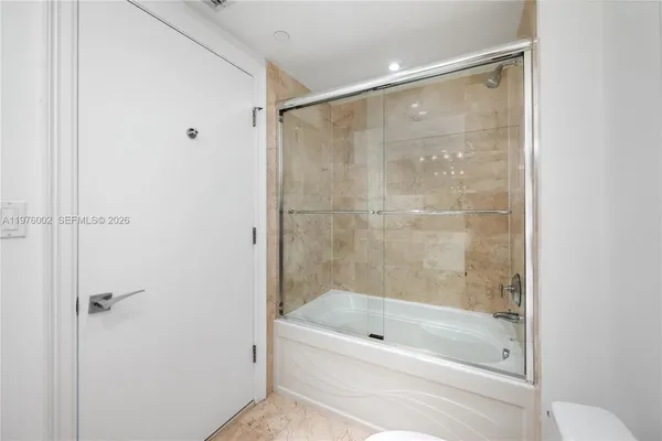 a bathroom with a shower and a bath tub