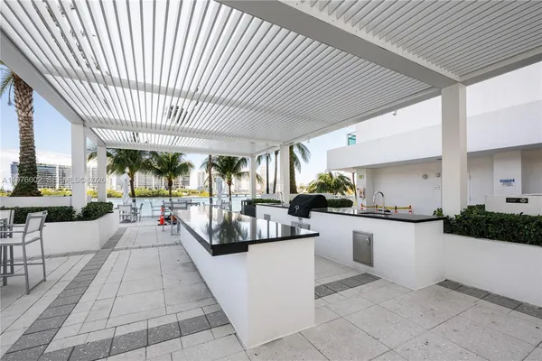 a kitchen with stainless steel appliances kitchen island granite countertop a sink and cabinets