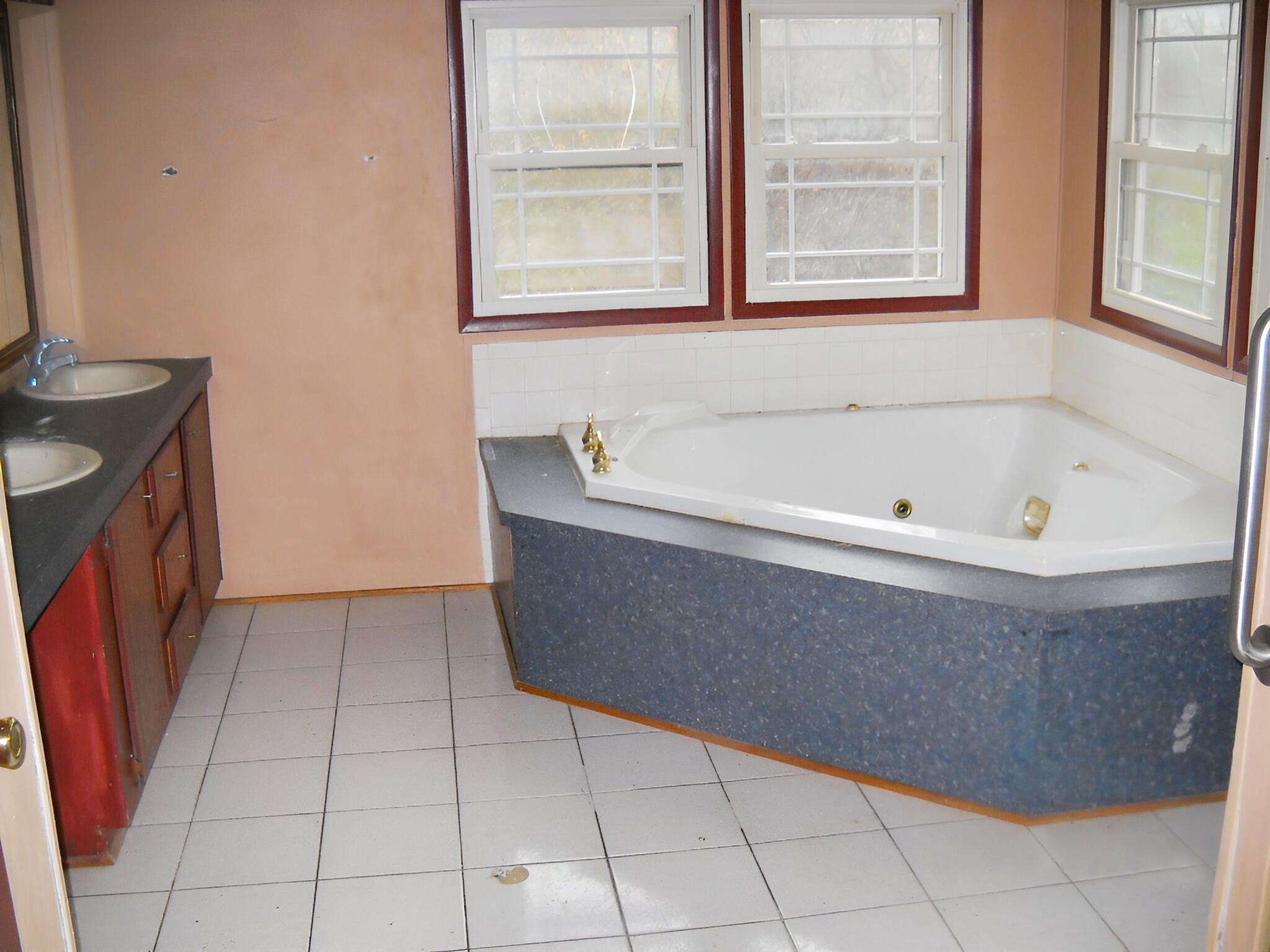 105 Piney Branch Road Blue Ridge, VA 24064 - Photo 4 of 12 a bath tub sitting in a bathroom next to a window