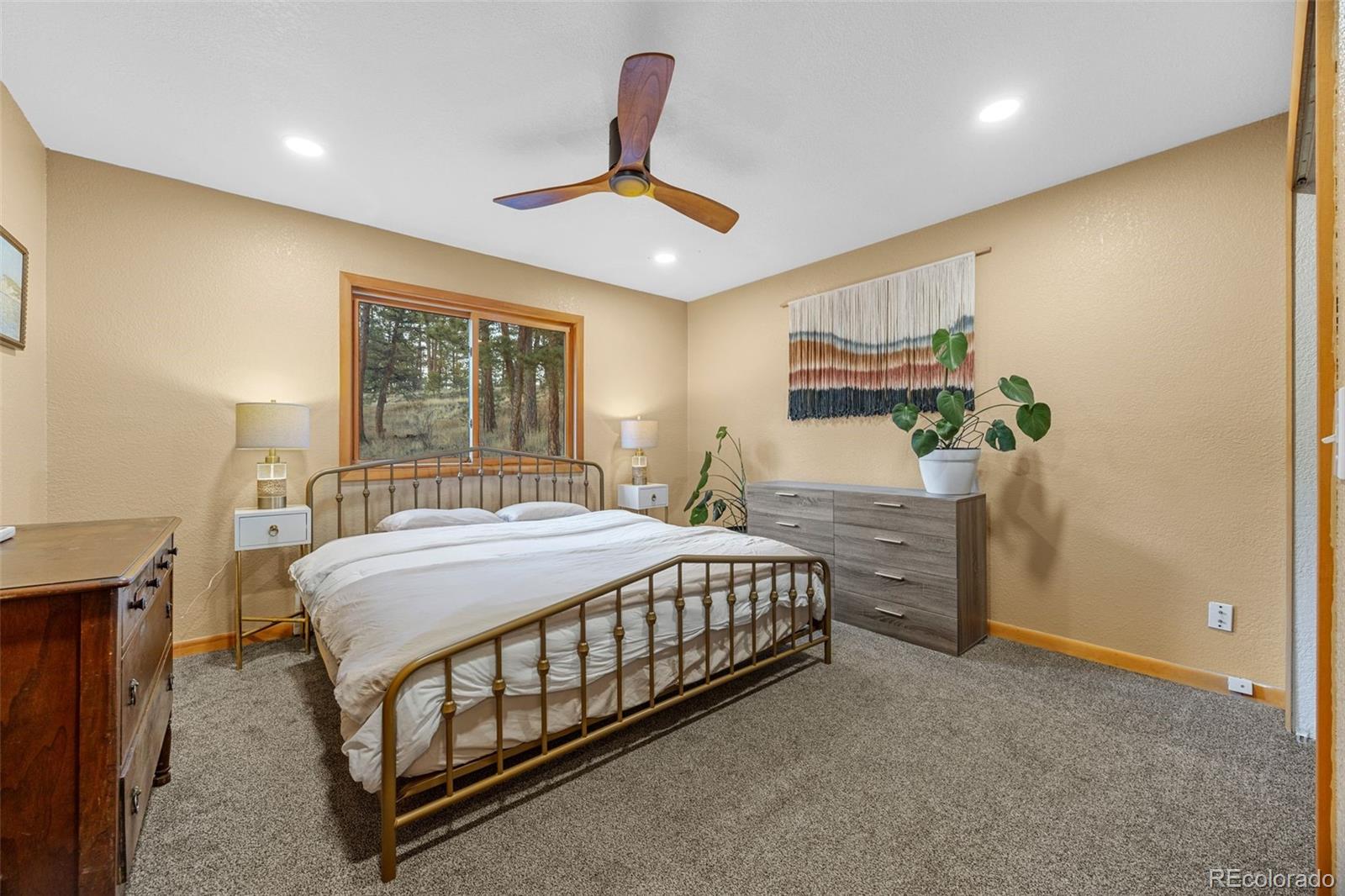 22 Driver Road Bailey, CO 80421 - Photo 11 of 24 a bed room with a bed and a chandelier