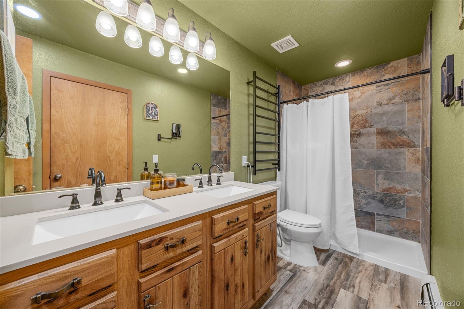 22 Driver Road Bailey, CO 80421 - Photo 12 of 24 a bathroom with a double vanity sink mirror double and toilet