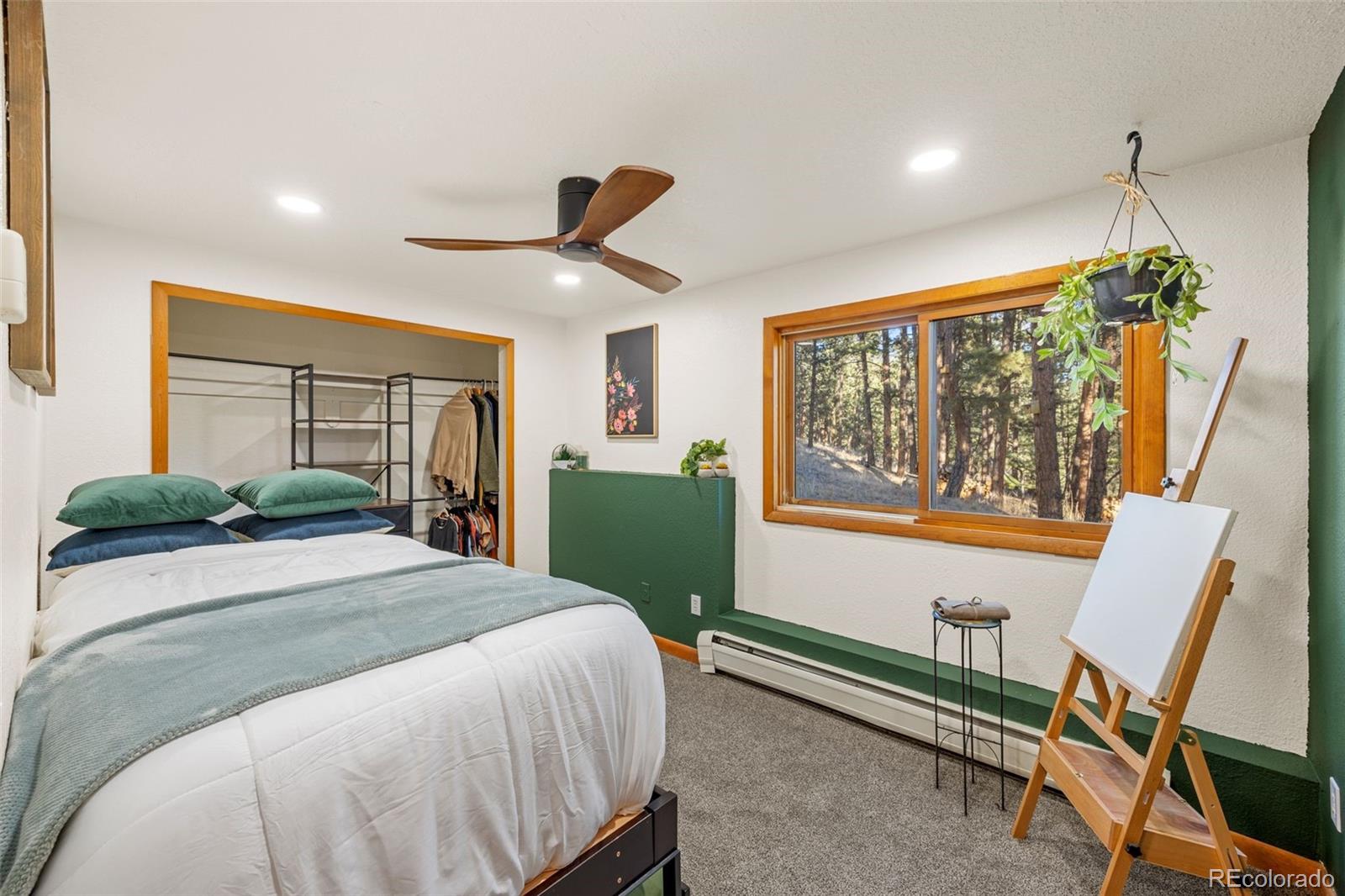 22 Driver Road Bailey, CO 80421 - Photo 17 of 24 a bed room with a bed and a chair