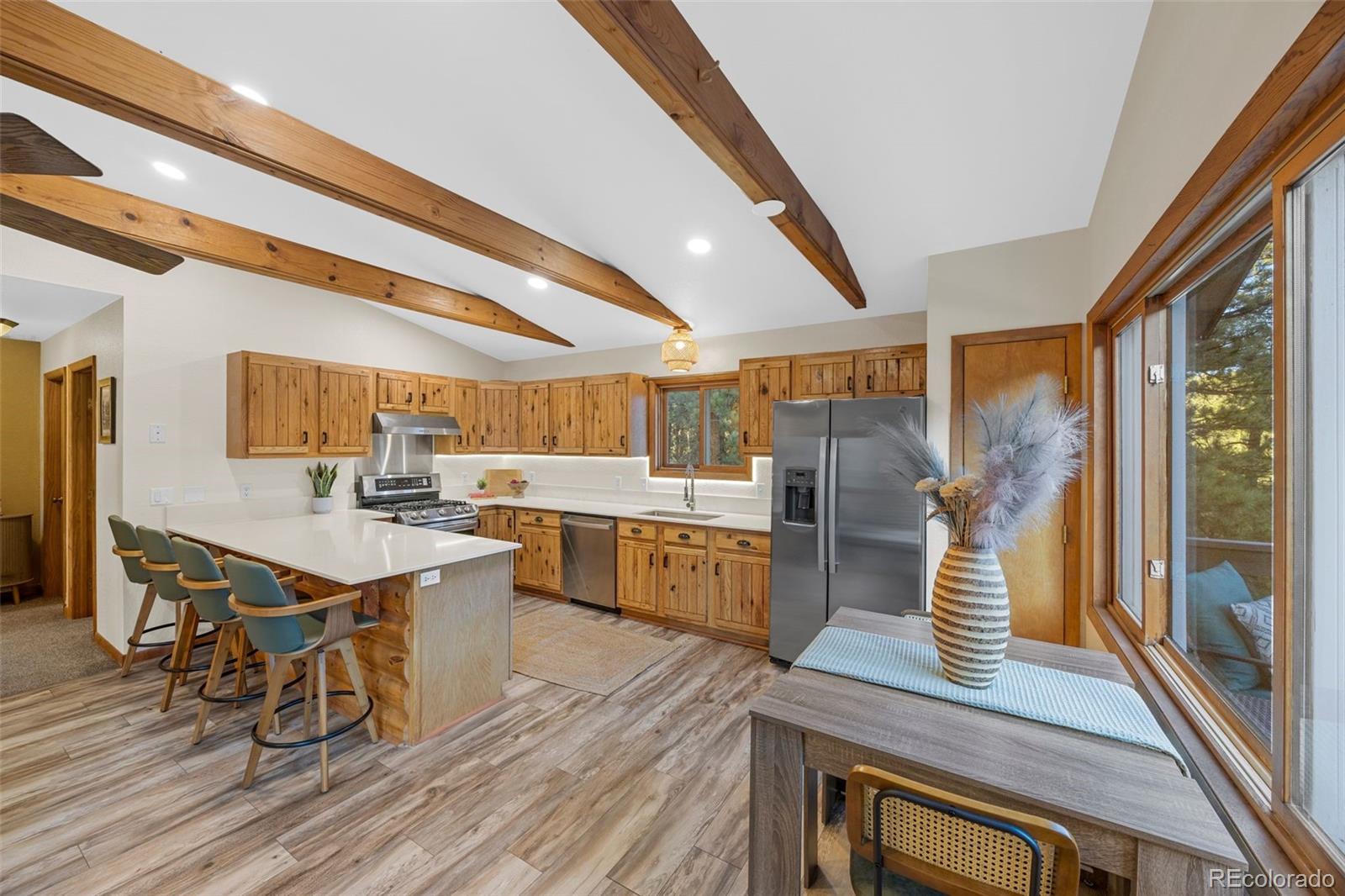 22 Driver Road Bailey, CO 80421 - Photo 3 of 24 a kitchen with lots of counter top space and painting on the wall