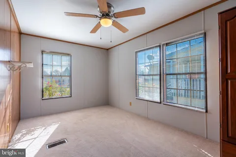 an empty room with windows and closet