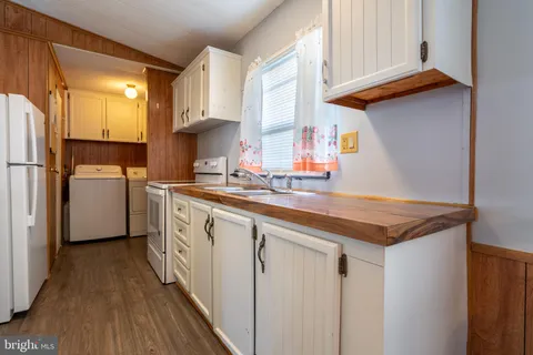 a kitchen with stainless steel appliances granite countertop a sink and a refrigerator