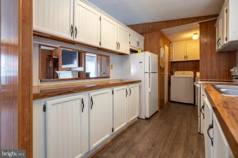 a kitchen with a sink cabinets stainless steel appliances and a window