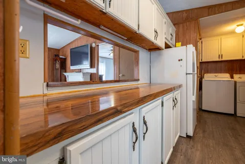 a kitchen with a refrigerator and a stove