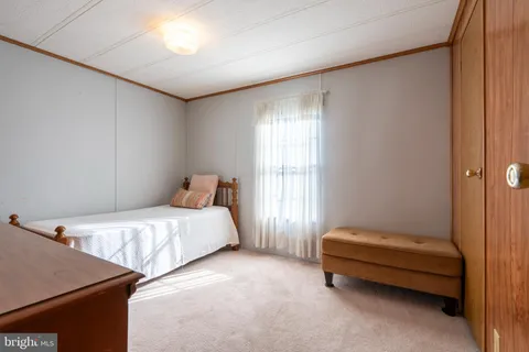 a bed room with a bed and a window