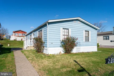 a front view of house with yard and green space