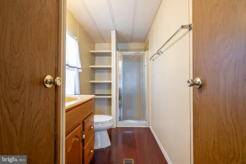 a bathroom with a sink a toilet and a shower