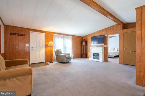 a view of an empty room with a fireplace and a window