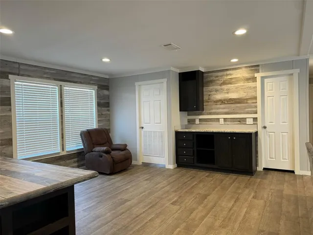 a living room with stainless steel appliances kitchen island granite countertop furniture a refrigerator and a stove