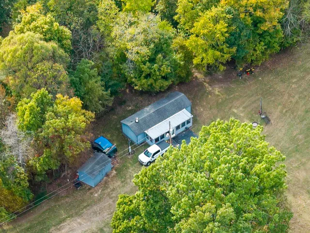 an aerial view of a house with a yard