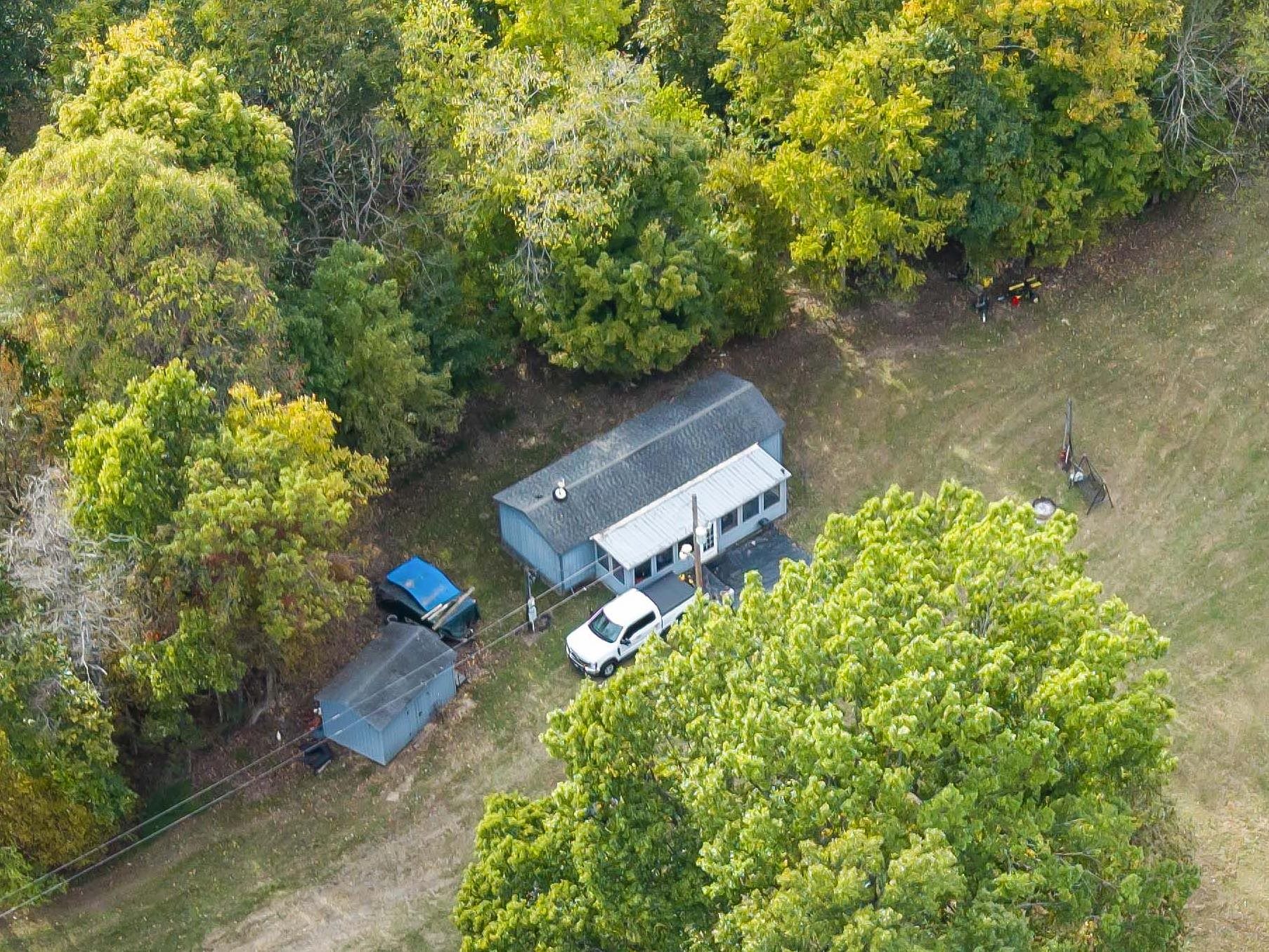 an aerial view of a house with a yard