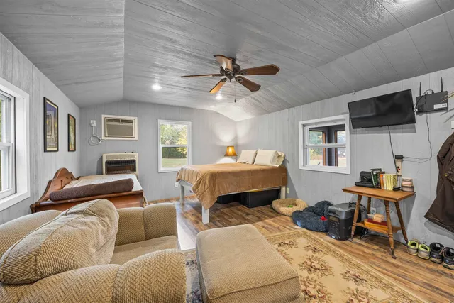 a living room with furniture and large windows