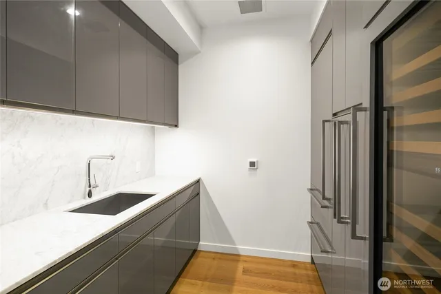 a kitchen with a sink and refrigerator